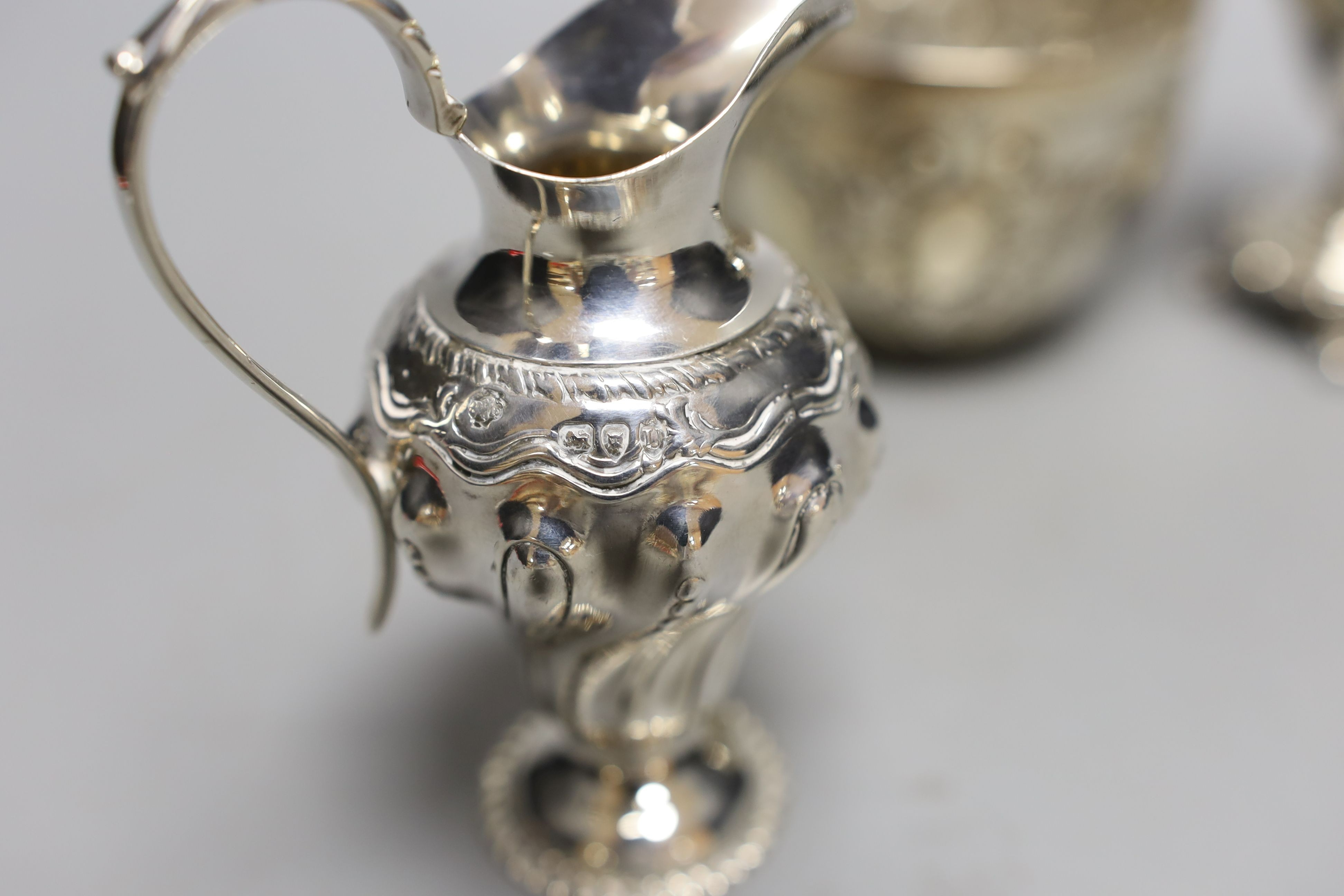 Two late 19th/early 20th century silver cream jugs, 13.5cm, and a late Victorian silver sugar bowl, 10oz.